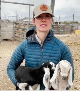 O'Neal holds two week-old milking goats in her arms at her ranch 